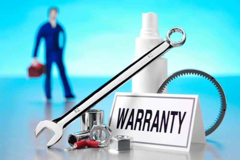 sign that reads warranty with a mechanic and tools