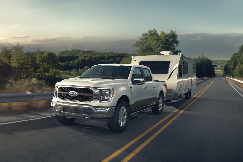 white ford f-150 towing a travel trailer
