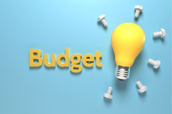 the word budget next to a light bulb