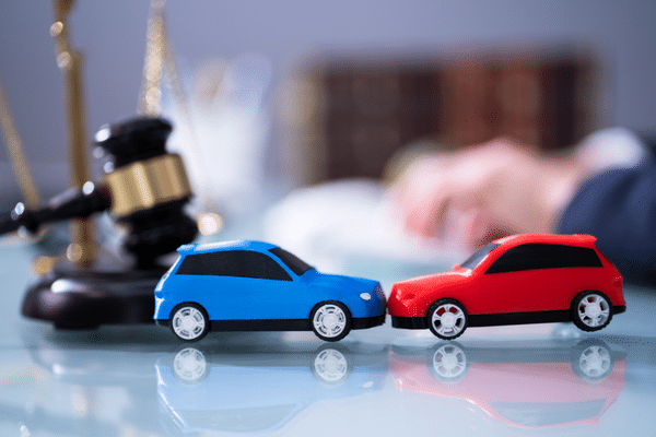 gavel and toy cars on desk to represent car auction