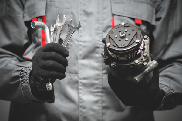mechanic holding car parts